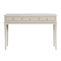 A console table with three drawers, featuring a light gray top and a warm beige body with gold-toned round knobs and slender legs.
