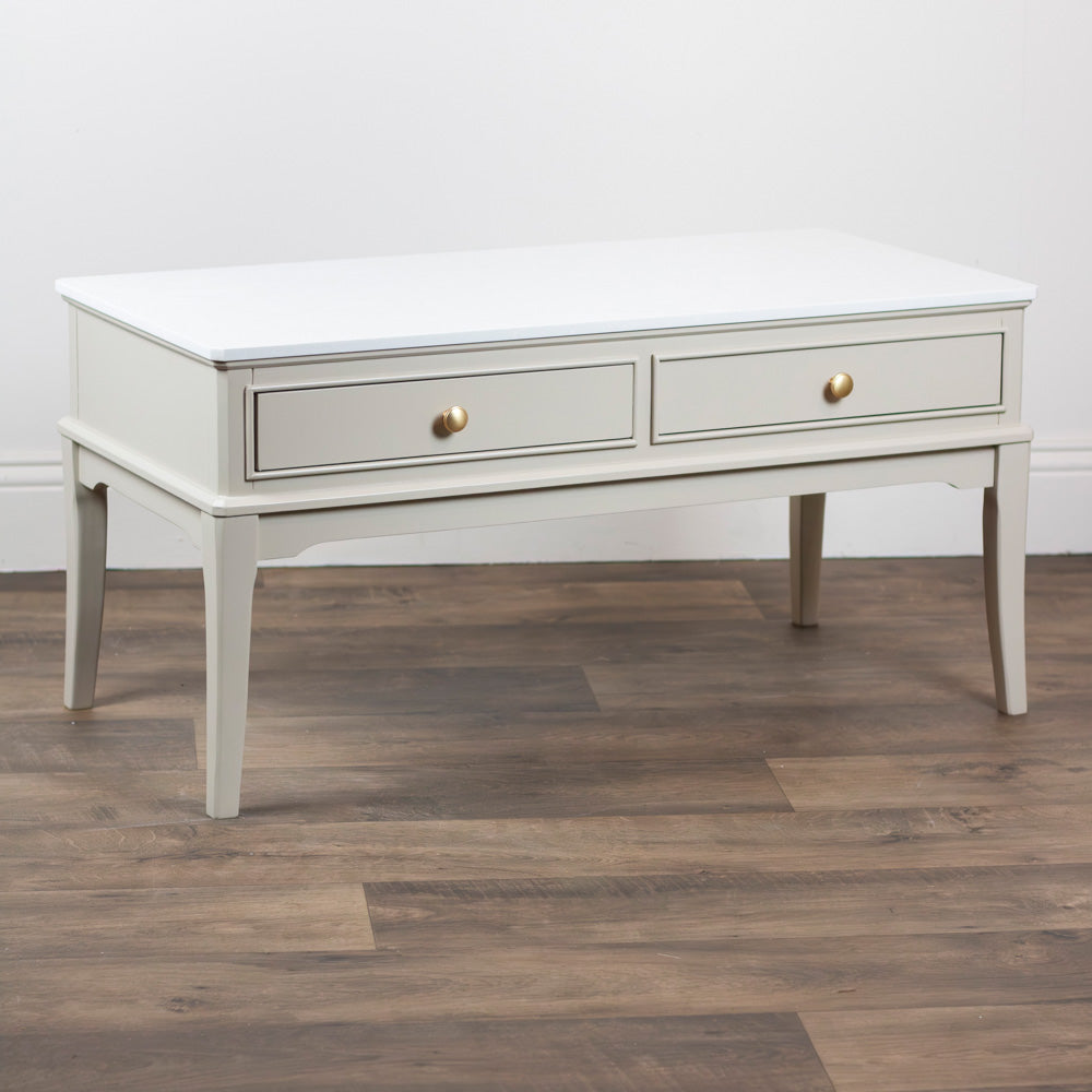 Monroe Coffee Table in Stone with two drawers on a wooden floor
