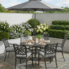 Outdoor patio set with table, chairs, and umbrella in a garden setting