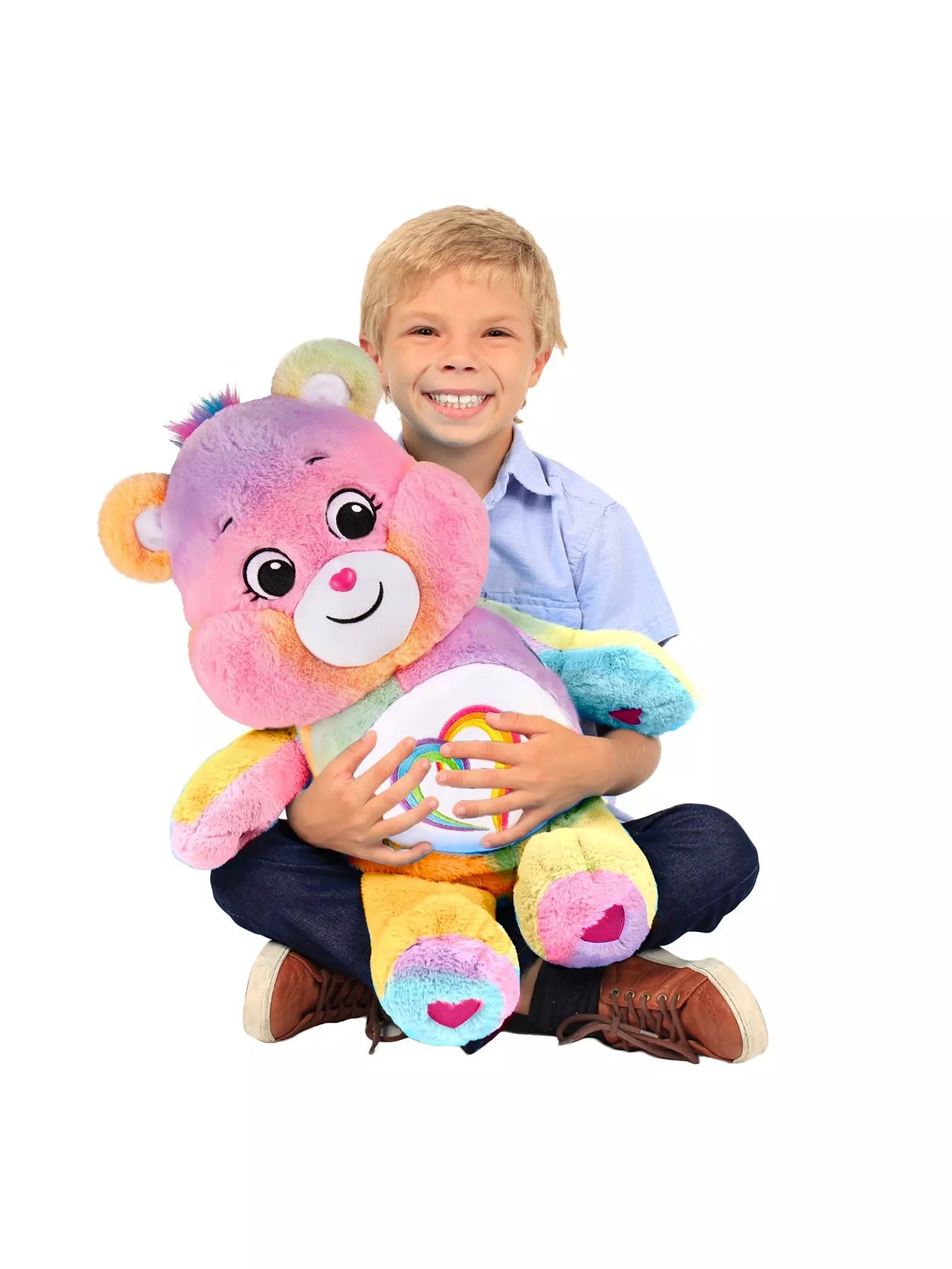 Child holding a colorful plush toy with a white background