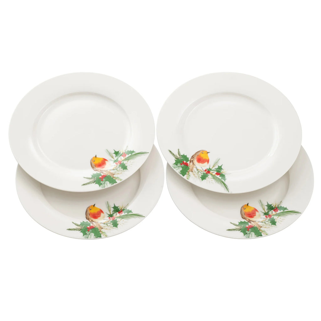 Set of four white plates with decorative robin and holly on a white background