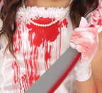 Person wearing a white dress with red stains holding a knife.