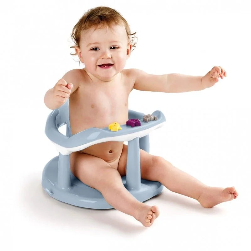 A baby sitting in a light blue plastic bath seat with a small activity tray, photographed on a clean white background.