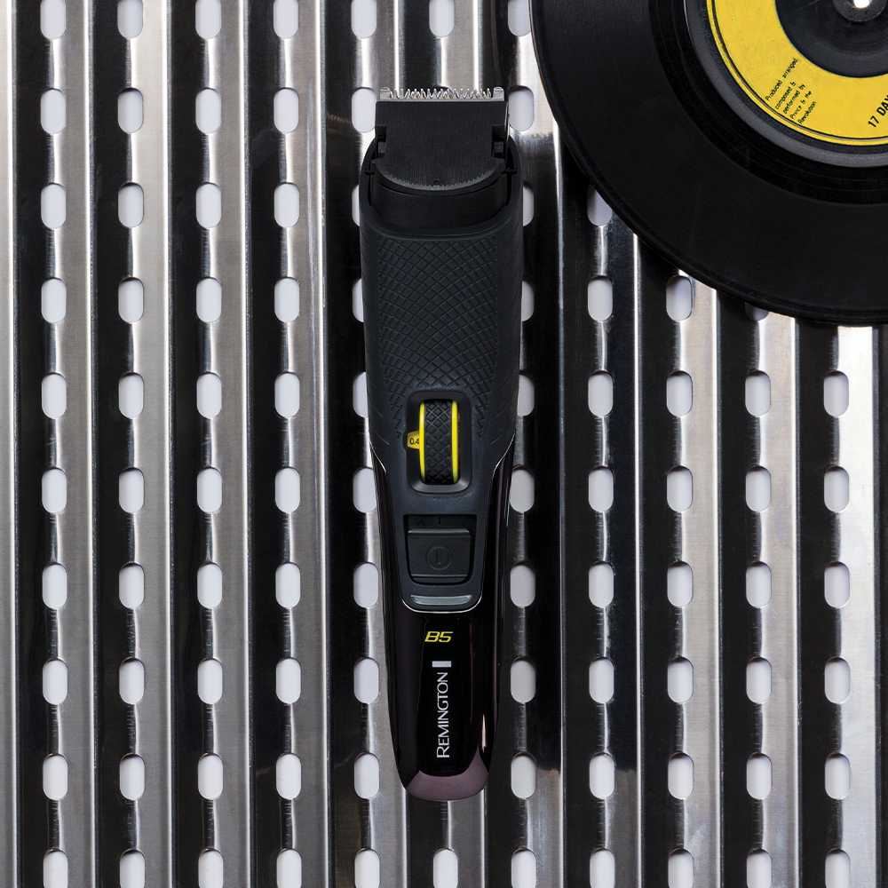 Black and yellow grooming tool on a metallic surface