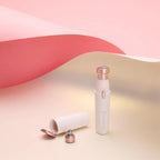 White and rose gold electronic device on a pink and beige background