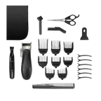 Set of grooming tools including a hair clipper, scissors, and multiple attachments on a white background.
