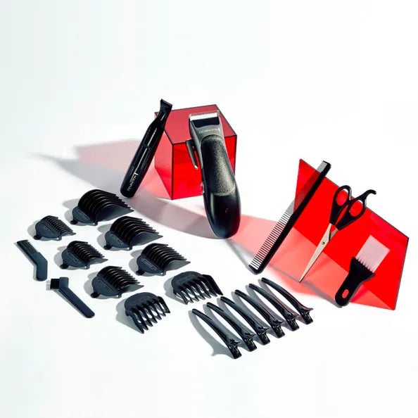 Set of black hair styling tools including clippers, scissors, and combs on a white background.
