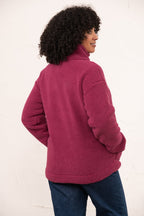 Person wearing a pink fleece jacket on a white background