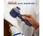 Hand holding a blue fabric shaver with 'Russell Hobbs' branding, text 'Refresh your wardrobe' above.