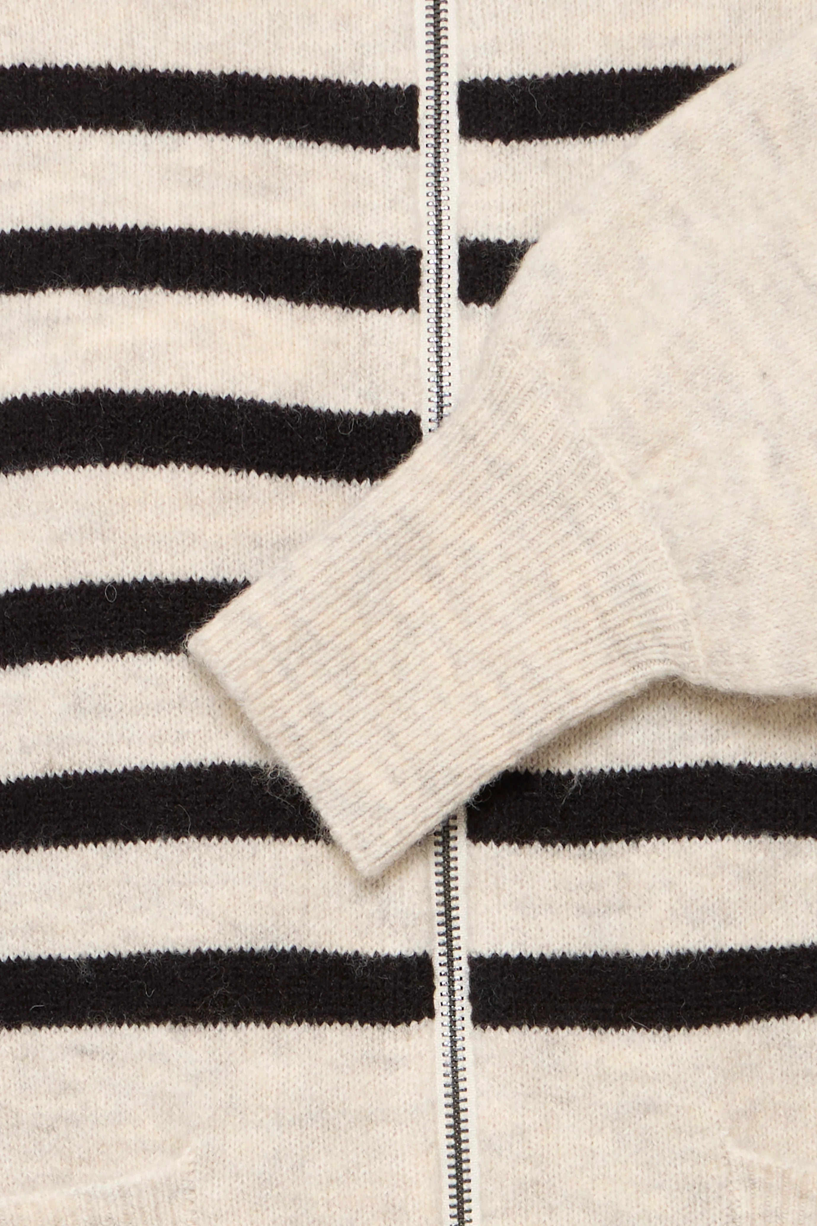 Elvira Cardigan from Fransa close up of the metal zip, the beige base colour and the black stripes. 