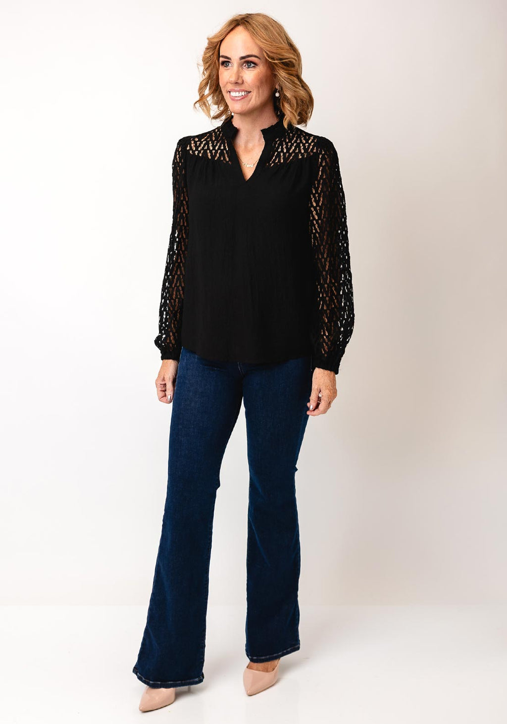 Fransa Bess blouse in black with laser‑cut chevron sleeves and frill‑trimmed V‑neck, loose hip‑length fit
