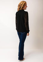 Fransa Bess blouse in black with laser‑cut chevron sleeves and frill‑trimmed V‑neck, loose hip‑length fit