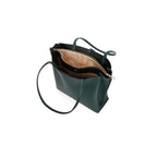 Green handbag with a beige interior on a white background