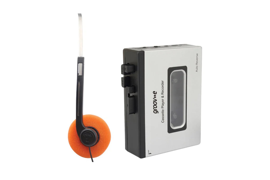 A silver and black cassette player and its matching orange-and-black wired headphones shown on a plain white background.