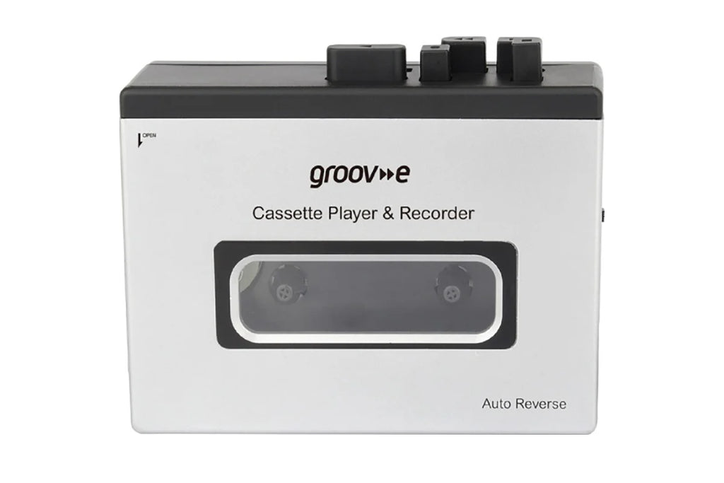 A white and black Groovee cassette player and recorder device with a transparent window showing the internal tape reels, set against a plain white background.