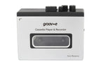 A white and black Groovee cassette player and recorder device with a transparent window showing the internal tape reels, set against a plain white background.
