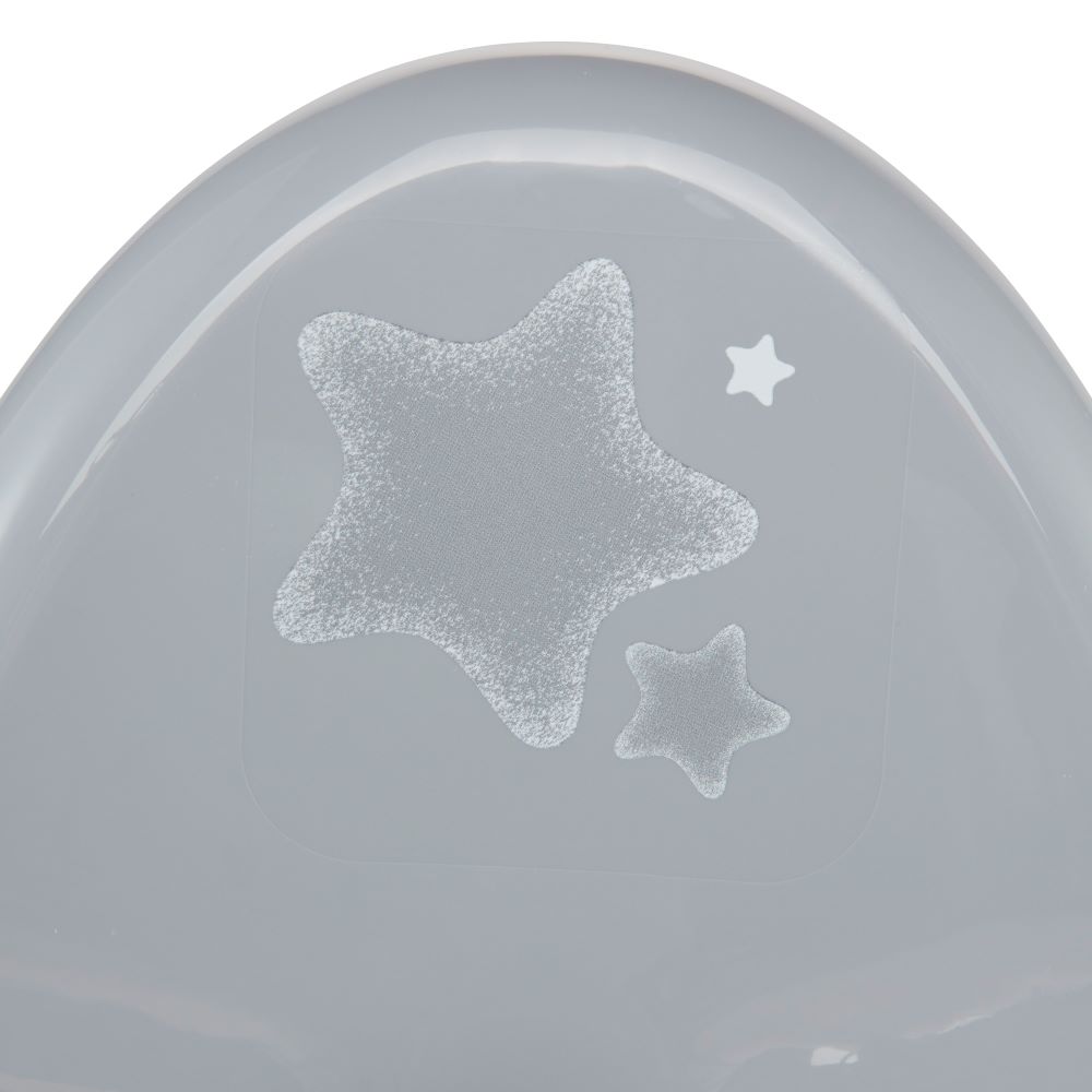 A close-up of a light gray plastic surface with two frosted star decals, one large and one small, on a white background.