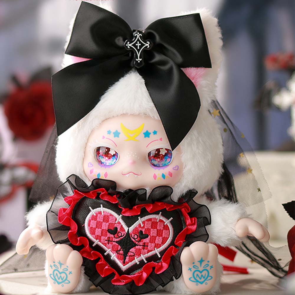 Stuffed toy with a large black bow, checkered heart, and colorful face on a blurred background
