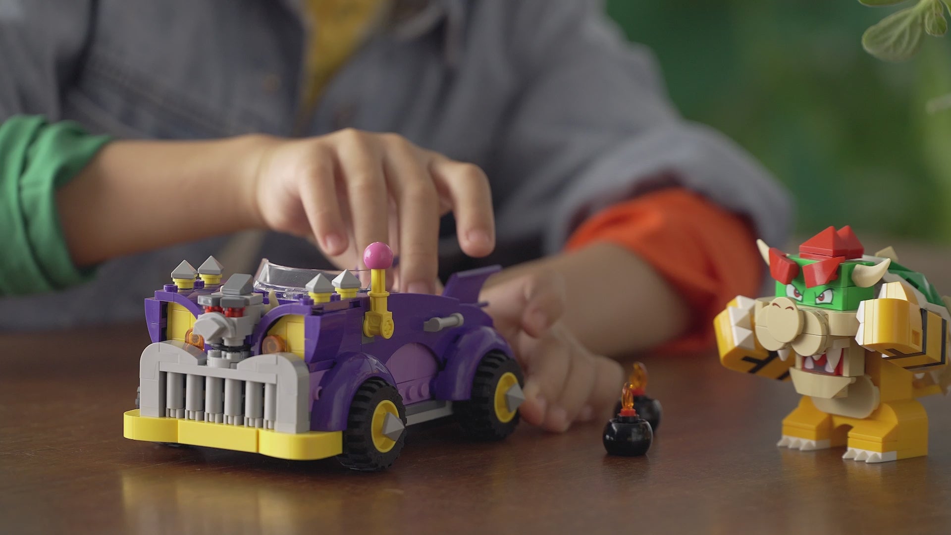 LEGO Super Mario Bowser’s Muscle Car Expansion Set (71431) showing purple muscle car, Bowser figure with Action Tag, yellow lever and bomb pieces.