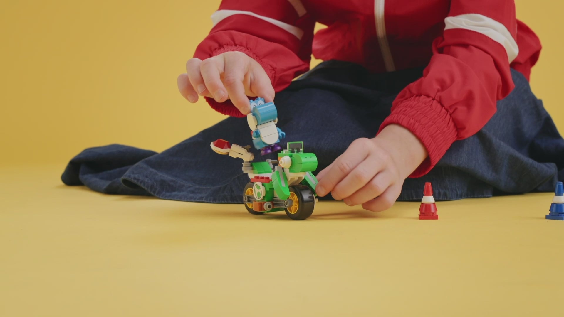 LEGO Super Mario Mario Kart Yoshi Bike set (72031) with Light-Blue Yoshi figure, bricks built bike, traffic cones, banana obstacle and shell-launching feature.