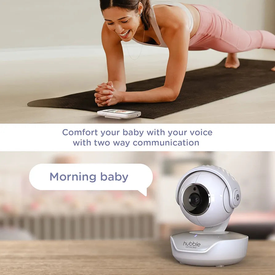 Woman exercising on a mat with a baby monitor displaying 'Morning baby' text.