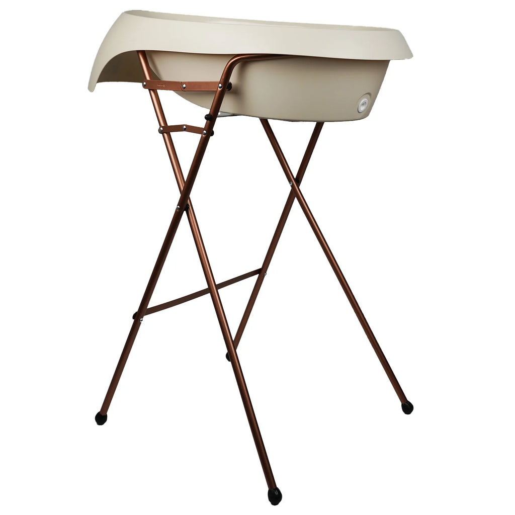 Beige folding bath tub  with bronze legs on a white background