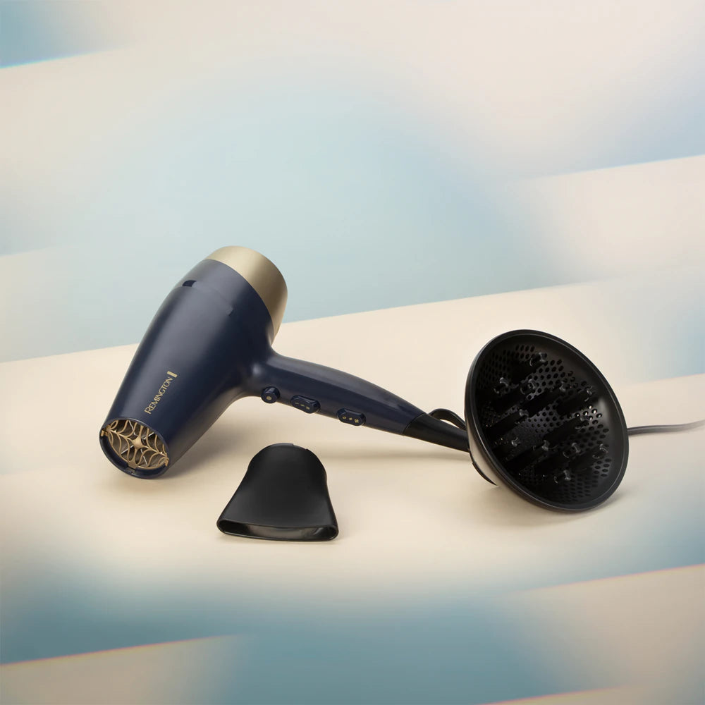 Blue hair dryer with attachments on a light background