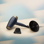 Blue hair dryer with attachments on a light background