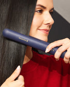Woman using a Remington hair straightener on her hair