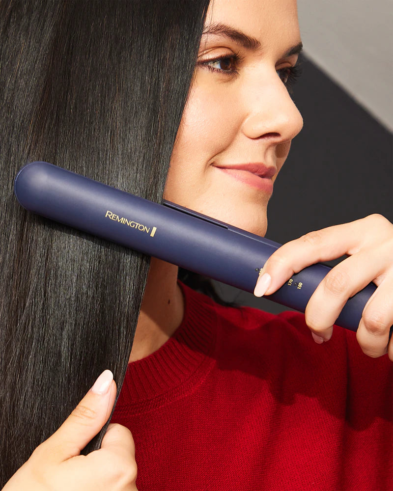 Woman using a Remington hair straightener on her hair