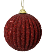 Red glittery Christmas ball ornament on a white background