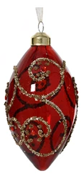 Decorative red ornament with gold swirls on a white background