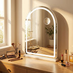Hollywood arch vanity mirror lit up on a dressing table