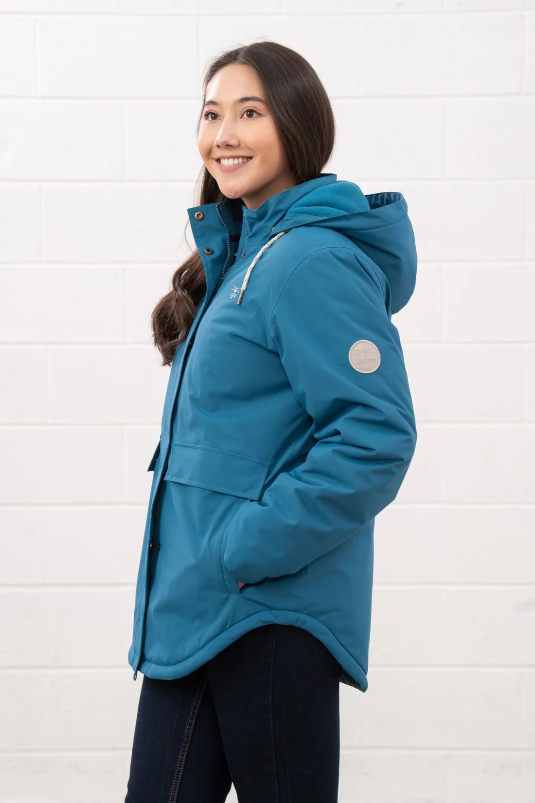 Woman wearing a blue jacket against a white background