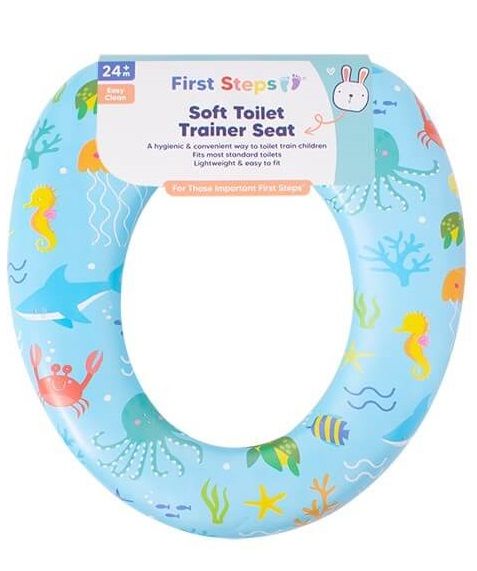 First Steps brand soft toilet trainer seat in light blue with a colorful ocean-themed pattern of sea creatures, shown with its product packaging label.