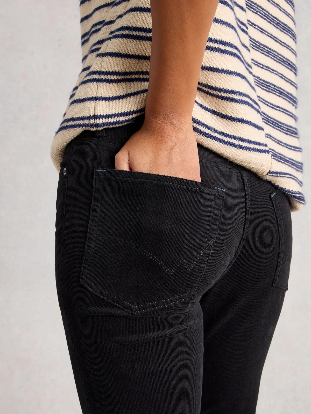 Person wearing Brooke Cords and a striped sweater on a plain background