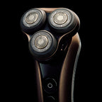 Electric shaver with three heads on a black background