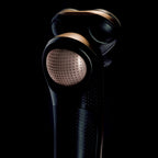 Black hair dryer with a textured nozzle on a black background